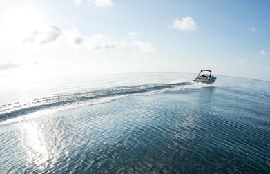 boat on water into sunset